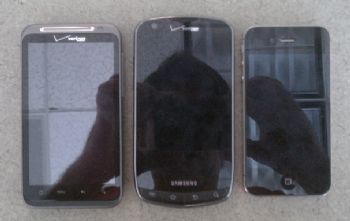 The Charge is larger than the HTC ThunderBolt (left) and the iPhone 4 (right).