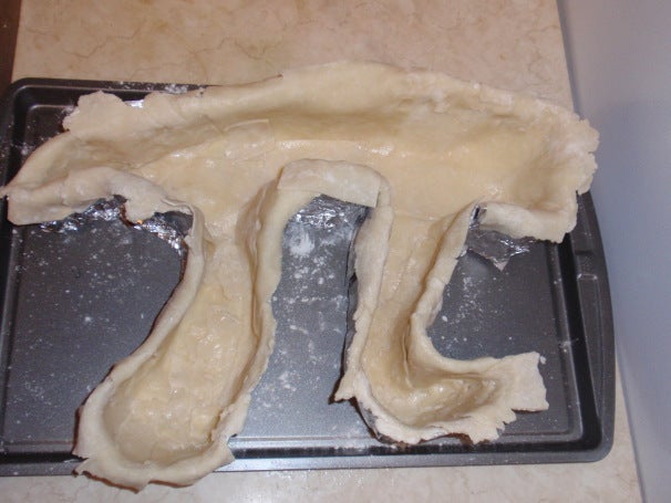 The pi bottom crust in the pi mold.